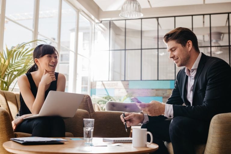 Business professional meeting in lobby of modern office