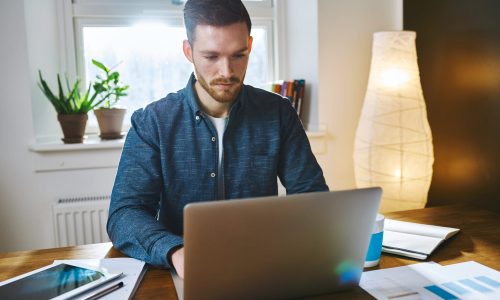 Concentrated man working on laptop